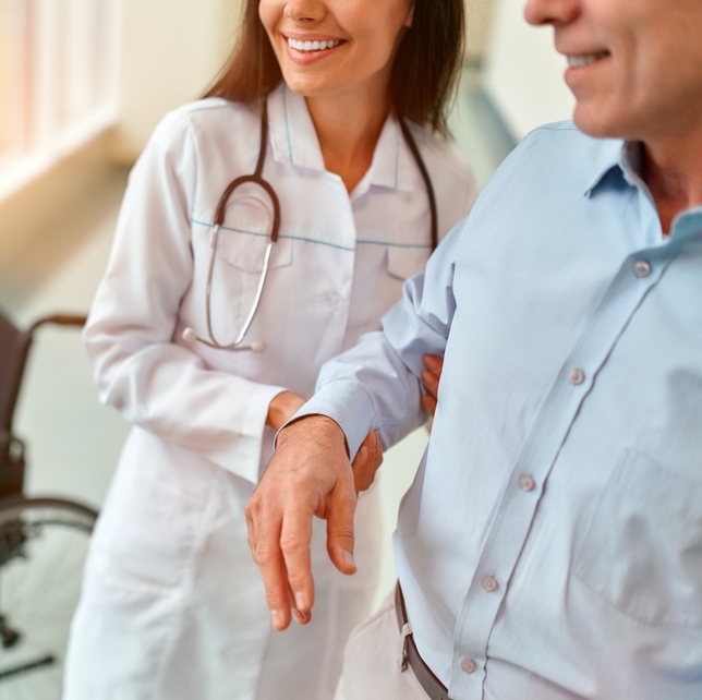 A,Dedicated,Healthcare,Professional,Is,Helping,A,Patient,Walk,Steadily