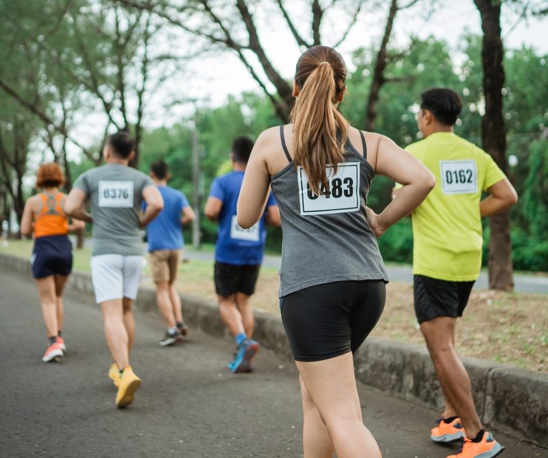 Back,View,Of,Female,Athlete,Participating,At,Marathon,Competition