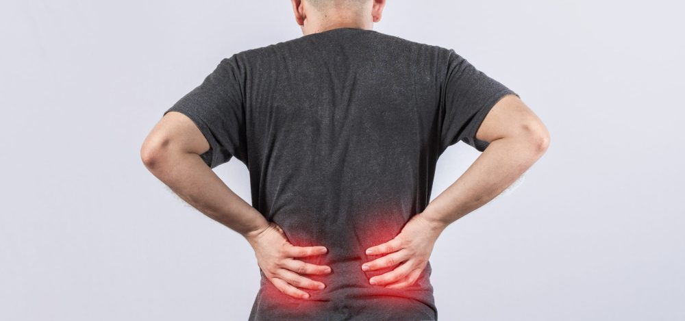 Man with spine problems, person with back problems on isolated background, lumbar problems concept, a sore man with back pain