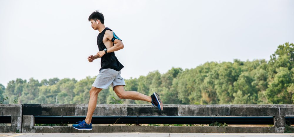 Men exercise by running on the road on the bridge.