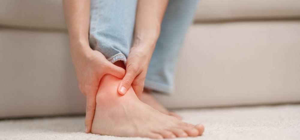 woman having leg pain due to Ankle Sprains or Achilles Tendonitis and Shin Splints ache. injuries, health and medical concept